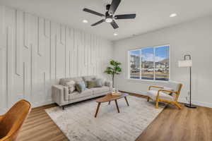 Living area featuring light wood-type flooring, ceiling fan, and recessed lighting