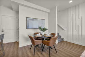 Dining room featuring stairway and wood finished floors