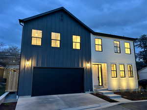 Modern farmhouse featuring board and batten siding, concrete driveway, and an attached garage