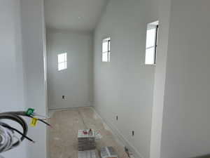 Spare room featuring lofted ceiling