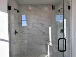 Primary Ensuite bathroom with a marble finish shower