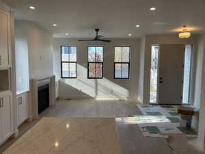 Foyer featuring recessed lighting, light wood-style floors, a fireplace, and a ceiling fan