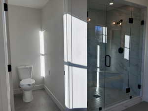 Primary Ensuite Bathroom with a marble finish shower and tile patterned flooring