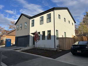 View of front facade featuring driveway and an attached garage