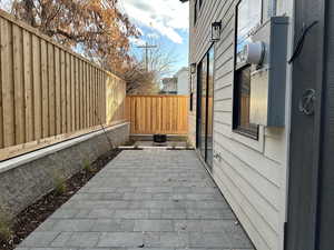 View of property exterior featuring a fenced backyard and a patio
