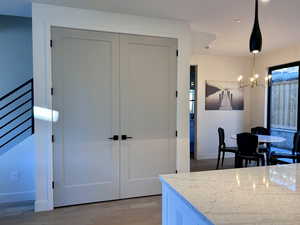 Kitchen featuring light wood-style floors, hanging light fixtures, a chandelier, and recessed lighting