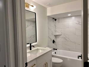 Full bath featuring vanity and shower / bath combination