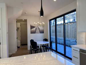 Dining room with recessed lighting, a chandelier, and wood finished floors