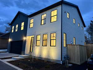 View of front facade featuring a garage and board and batten siding