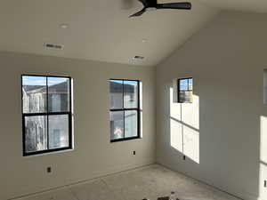 Unfurnished room featuring vaulted ceiling and a ceiling fan