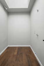Laundry area featuring dark wood-style flooring and hookup for a gas dryer