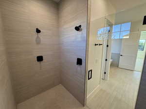 Full bath with a stall shower and a soaking tub