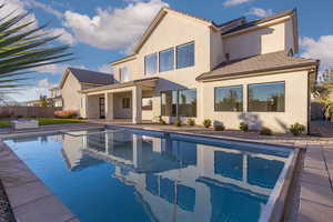 Back of property with a patio, a tile roof, and stucco siding