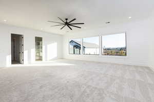 Spare room with light carpet, recessed lighting, and a ceiling fan