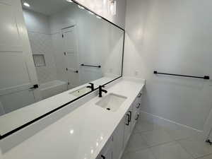 Bathroom featuring vanity, shower / washtub combination, light tile patterned floors, and recessed lighting