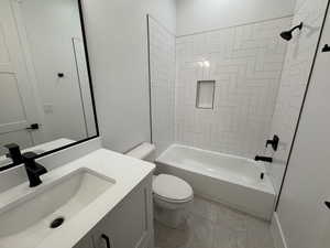 Bathroom with bathtub / shower combination, vanity, and light tile patterned floors