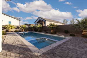 View of swimming pool with a fenced backyard, a patio area, and a pool with connected hot tub