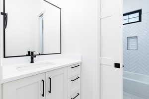 Bathroom featuring vanity and  shower combination