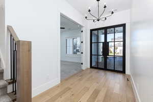 Unfurnished dining area featuring light wood-style flooring and a chandelier