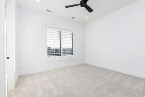 Spare room featuring light carpet, a ceiling fan, and recessed lighting