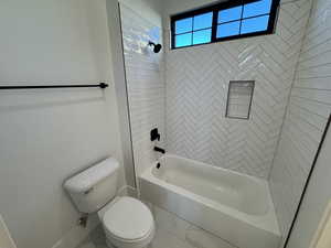 Bathroom featuring shower / bathtub combination and toilet