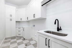 Laundry room featuring light flooring, cabinet space, and hookup for a washing machine