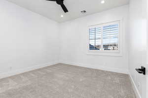 Carpeted spare room featuring recessed lighting and a ceiling fan