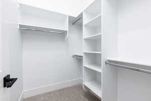 Walk in closet with light carpet