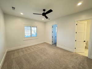 Empty room with recessed lighting, light carpet, and ceiling fan