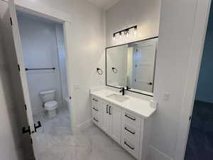 Bathroom with vanity and light marble finish floors