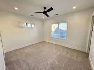 Empty room featuring recessed lighting, carpet, and ceiling fan