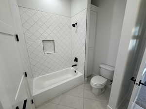 Full bathroom with  shower combination and light tile patterned flooring