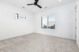 Unfurnished room with plenty of natural light, light colored carpet, ceiling fan, and recessed lighting