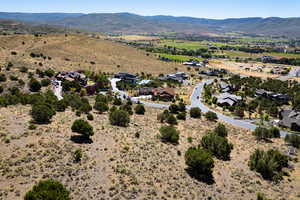 Aerial view of sparsely populated area with a mountain backdrop and nearby suburban area