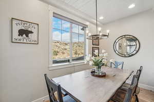 Dining room featuring a chandelier, wood finished floors, wood ceiling, and recessed lighting