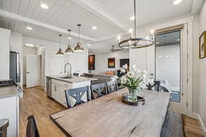 Dining space featuring recessed lighting, a ceiling fan, light wood-style flooring, and a wooden ceiling with exposed beams