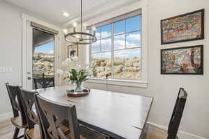 Dining space featuring a chandelier, wood finished floors, and recessed lighting