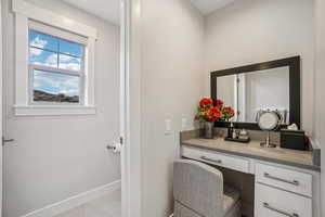 Bathroom featuring vanity and baseboards