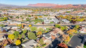 Aerial view of property's location with nearby suburban area and a mountain backdrop