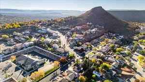 Aerial overview of property's location with a mountain backdrop and nearby suburban area