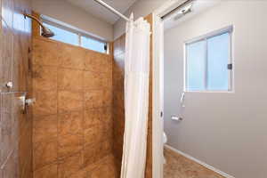 Full bathroom with a stall shower and tile patterned flooring