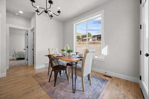 Dining space with a chandelier and light wood-style flooring
