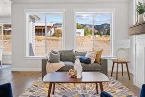 Living area with plenty of natural light and wood finished floors