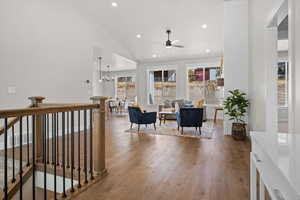 Sitting room with lofted ceiling, a chandelier, recessed lighting, a ceiling fan, and wood finished floors