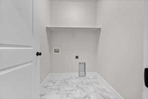 Laundry area featuring light marble finish floors, hookup for an electric dryer, and hookup for a washing machine