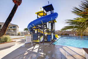 View of property's community with a swimming pool