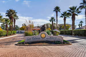 Community sign featuring decorative driveway