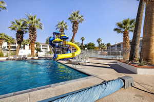 Community pool featuring a water slide
