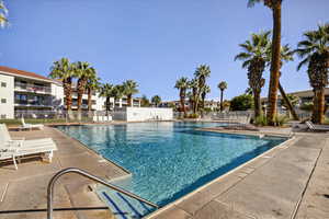Community pool with a patio