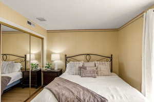 Bedroom with a closet and wood finished floors